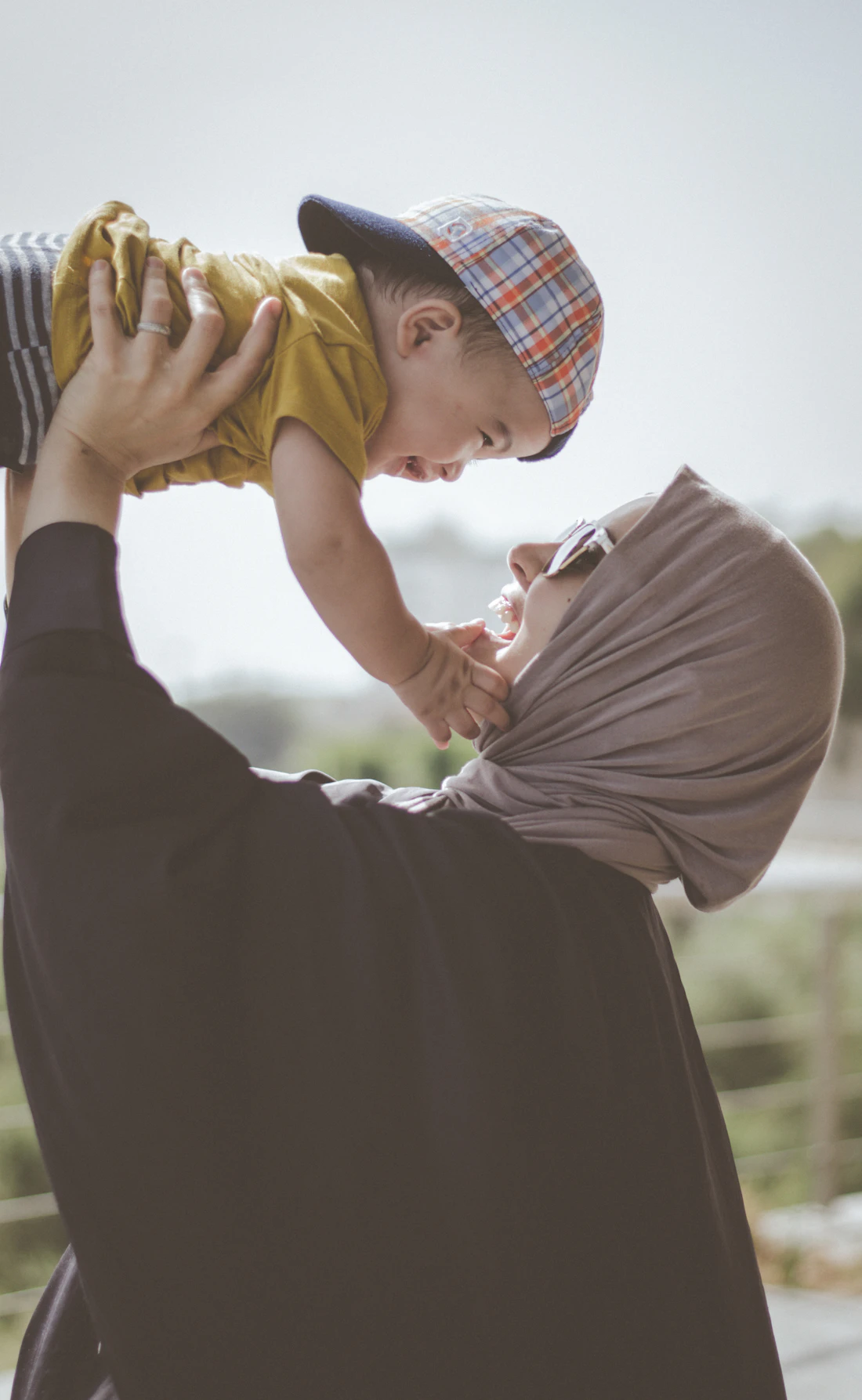 A parent holding a young child outdoors